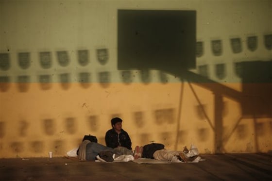 Migrants from Central America headed northwards towards the U.S. rest at a temporary shelter in Chahuites, in Mexico's southern state of Oaxaca, on Jan. 9. Just as they have done in the north, groups claiming to be Zetas have set up criminal networks to control transit routes for drugs, migrants, illegal DVDS and other consumer goods, intimidating the populace and committing gruesome murders as an example to the uncooperative. 
